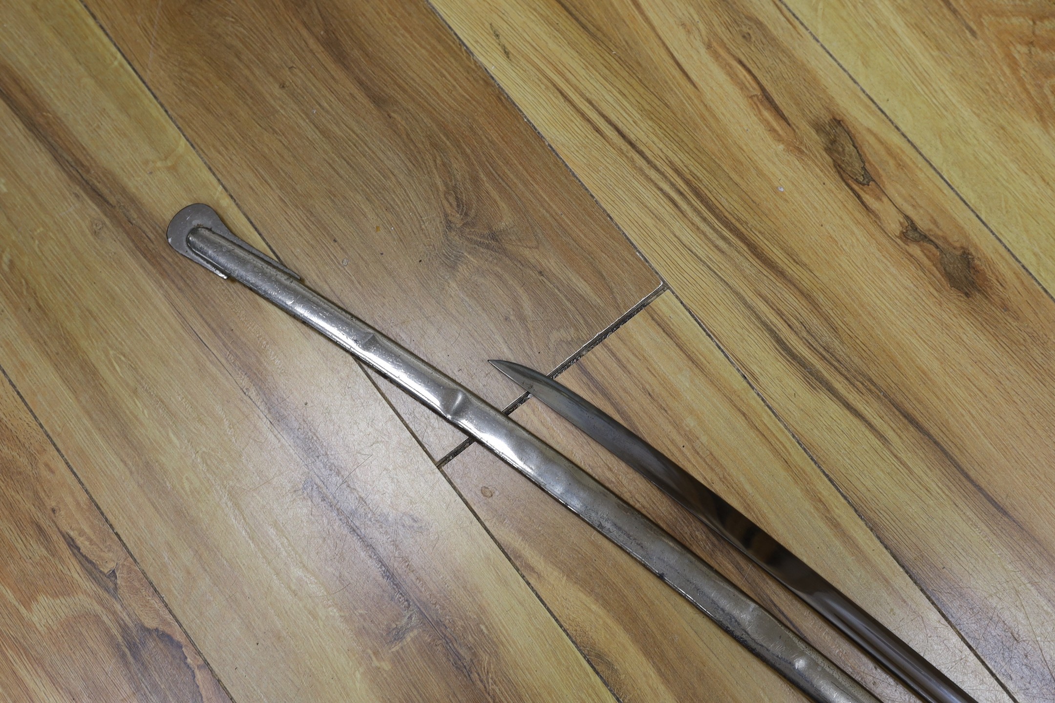A United States Marines dress sword made by Wilkinson, the blade etched ‘S/SGT. JAMES P.S. DEVEREUX II. 1340836 U.S.M.C.’ with scabbard. Total length 107cm